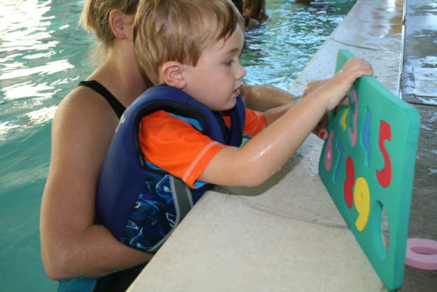 Img_25 young child plays in the water